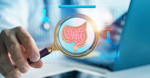 A hand holds a magnifying glass over a digital display of the human gut and medical charts in Biolongivity Science